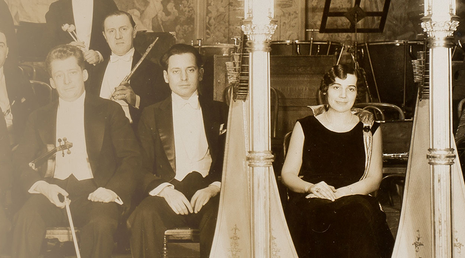 Photo of harpist Stephanie Goldner with male colleagues.
