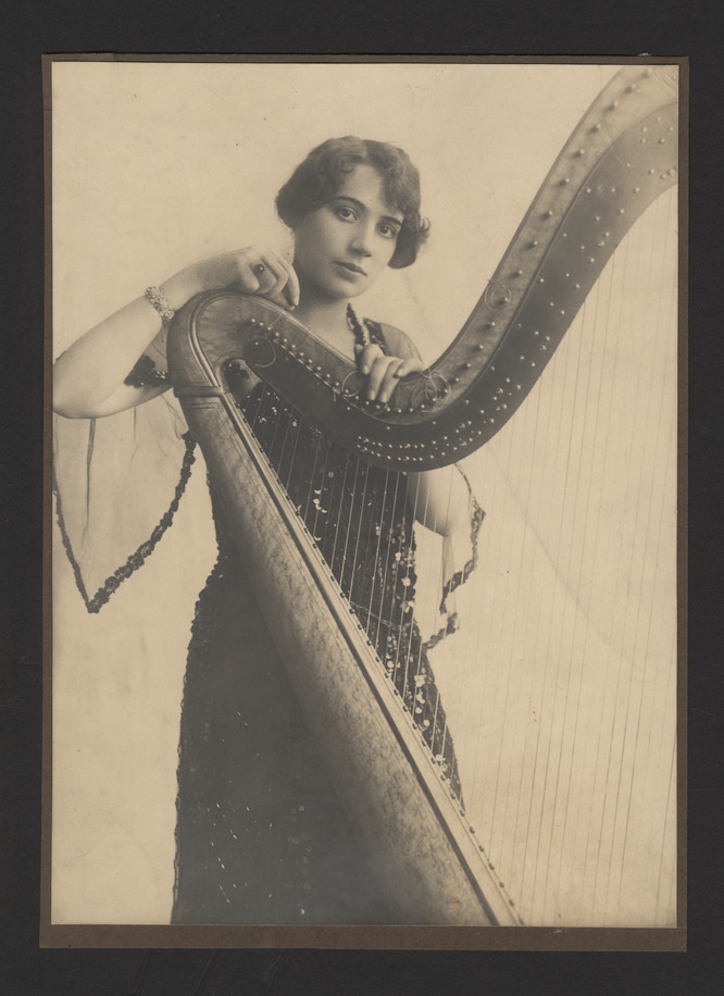 Portrait photograph of Steffy Goldner posing with harp